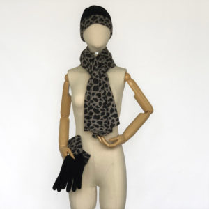 mannequin dressed in cheetah print scarf and hat while holding matching gloves