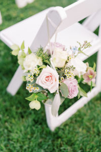 flowers tied to a white chair